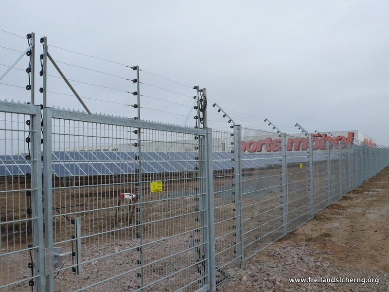 Objektsicherung an einem Doppelstabmattenzaun mit abgewinkeltem Drahtaufsatz und Solarpark-Absicherung